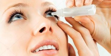woman instill eye drop